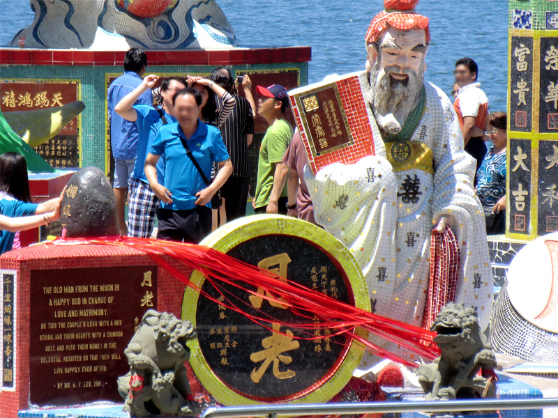 Le vieil homme de la lune et le rocher Yue Lao enserré dans des liens (à gauche)